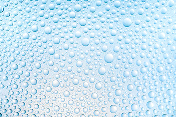 Blue water drops of on treat water-repellent surface in macro lens shot small-DOF for screen wallpapers