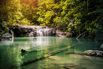 Waterfall in rain forest in summer, the warmest season of the year in Thailand.