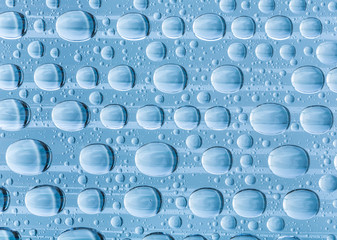 Blue water drops of on treat water-repellent surface in macro lens shot small-DOF for screen...