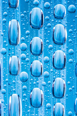 Blue water drops of on treat water-repellent surface in macro lens shot small-DOF for screen...