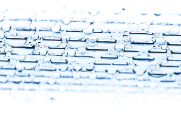 Blue water drops of on treat water-repellent surface in macro lens shot small-DOF for screen...