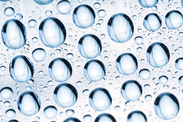 Blue water drops of on treat water-repellent surface in macro lens shot small-DOF for screen...