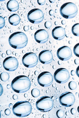 Blue water drops of on treat water-repellent surface in macro lens shot small-DOF for screen...