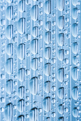 Blue water drops of on treat water-repellent surface in macro lens shot small-DOF for screen...