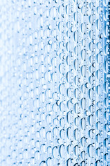 Blue water drops of on treat water-repellent surface in macro lens shot small-DOF for screen wallpapers