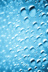Blue water drops of on treat water-repellent surface in macro lens shot small-DOF for screen...