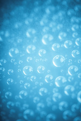 Blue water drops of on treat water-repellent surface in macro lens shot small-DOF for screen...