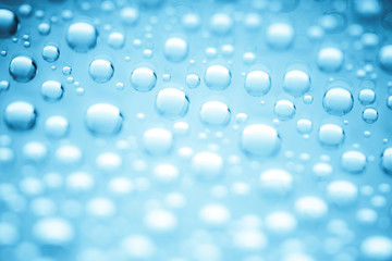 Blue water drops of on treat water-repellent surface in macro lens shot small-DOF for screen wallpapers