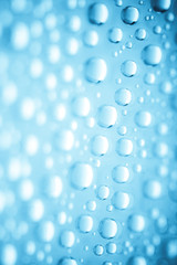 Blue water drops of on treat water-repellent surface in macro lens shot small-DOF for screen...