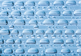 Blue water drops of on treat water-repellent surface in macro lens shot small-DOF for screen...