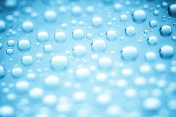 Blue water drops of on treat water-repellent surface in macro lens shot small-DOF for screen wallpapers
