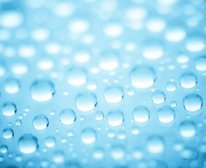 Blue water drops of on treat water-repellent surface in macro lens shot small-DOF for screen wallpapers