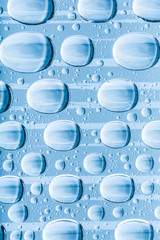 Blue water drops of on treat water-repellent surface in macro lens shot small-DOF for screen...