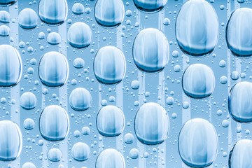 Blue water drops of on treat water-repellent surface in macro lens shot small-DOF for screen...