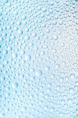 Blue water drops of on treat water-repellent surface in macro lens shot small-DOF for screen...