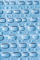 Blue water drops of on treat water-repellent surface in macro lens shot small-DOF for screen...