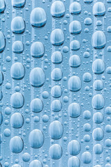 Blue water drops of on treat water-repellent surface in macro lens shot small-DOF for screen...