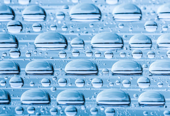 Blue water drops of on treat water-repellent surface in macro lens shot small-DOF for screen...