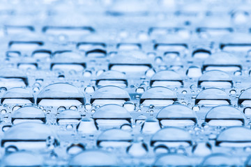 Blue water drops of on treat water-repellent surface in macro lens shot small-DOF for screen wallpapers