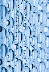Blue water drops of on treat water-repellent surface in macro lens shot small-DOF for screen...