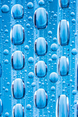 Blue water drops of on treat water-repellent surface in macro lens shot small-DOF for screen...