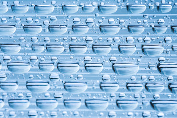 Blue water drops of on treat water-repellent surface in macro lens shot small-DOF for screen...