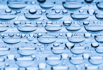 Blue water drops of on treat water-repellent surface in macro lens shot small-DOF for screen wallpapers