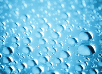 Blue water drops of on treat water-repellent surface in macro lens shot small-DOF for screen...