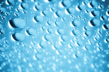 Blue water drops of on treat water-repellent surface in macro lens shot small-DOF for screen wallpapers