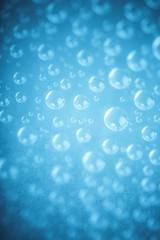 Blue water drops of on treat water-repellent surface in macro lens shot small-DOF for screen wallpapers