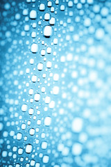 Blue water drops of on treat water-repellent surface in macro lens shot small-DOF for screen wallpapers