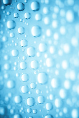 Blue water drops of on treat water-repellent surface in macro lens shot small-DOF for screen...