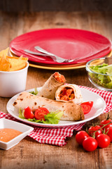 Tortilla wraps with chicken and vegetable.