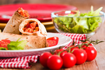 Tortilla wraps with chicken and vegetable.