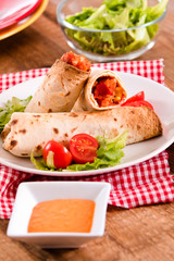 Tortilla wraps with chicken and vegetable.