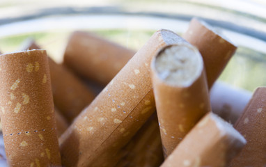 Closeup view of full ashtray.Cigarettes butts.