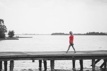 Woman in red jumpsuit at lake
