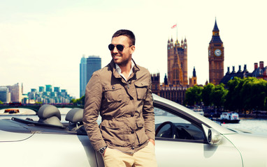 happy man near cabriolet car over london city