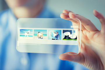 close up of woman with transparent smartphone