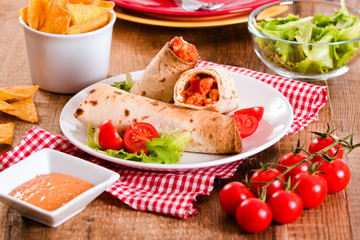 Tortilla wraps with chicken and vegetable.