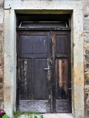 Old wooden doors in concrete wall