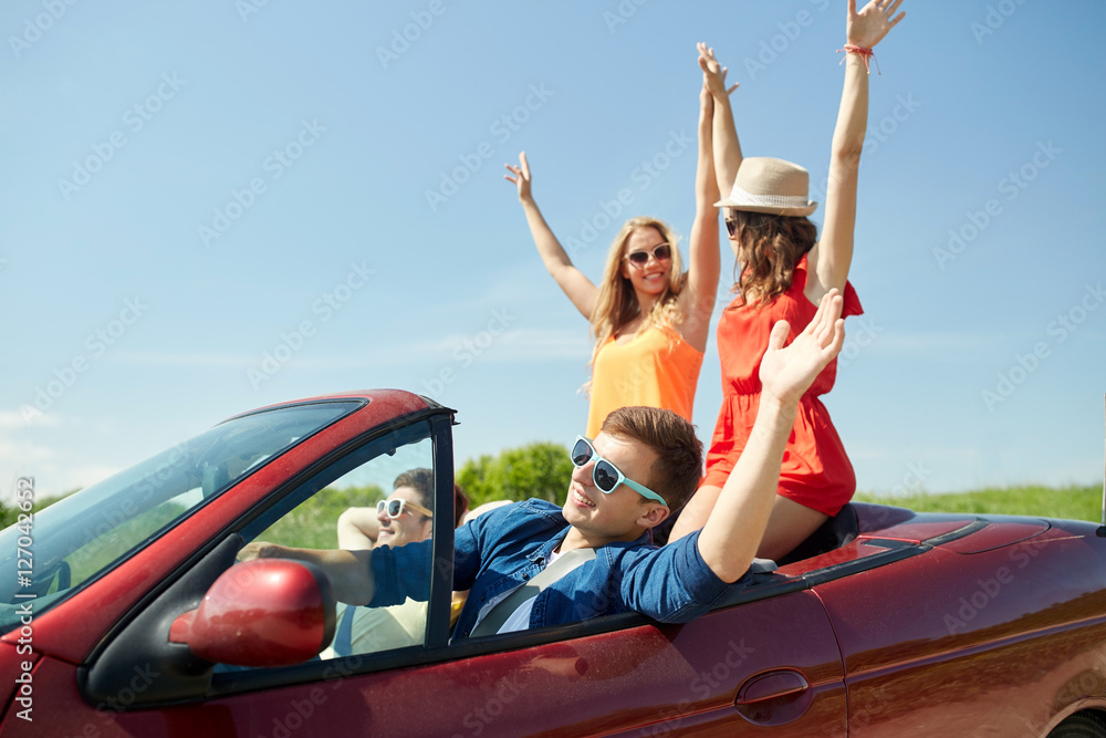 Canvas Prints happy friends driving in cabriolet car at country