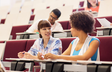 group of students talking in lecture hall