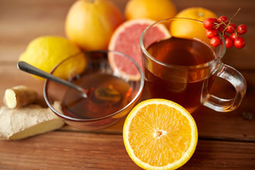 tea with honey, orange and rowanberry on wood