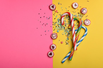 Candies and sprinkles on colorful background