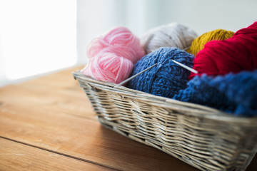 Fototapeta na wymiar basket with knitting needles and balls of yarn