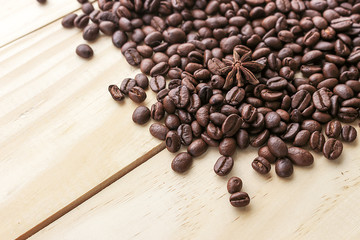 coffee beans on wood background, over light