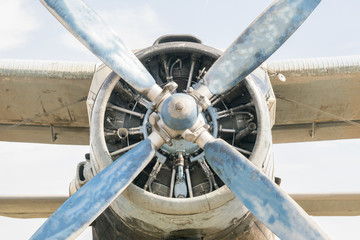 Part of a small blue and white plane on a background of blue sky
