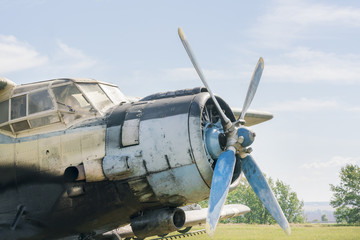 Part of a small blue and white plane on a background of blue sky