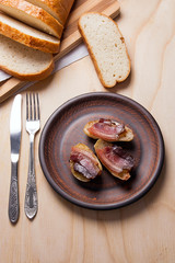 Baked potatoes with slices of bacon on wooden background. Slices